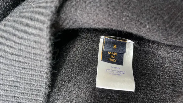 Black Knit Crewneck Sweater With Chest Graphic — warehouse QC photo 1
