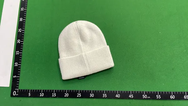 Ribbed Knit Cuffed Beanie With Triangle Badge — warehouse QC photo 2