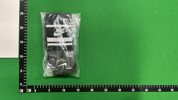 White Crew Socks With Orange And Black Stripes — warehouse QC photo 3