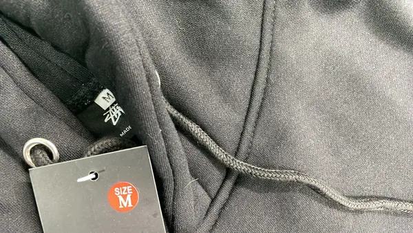 Black Hoodie With White Script Chest Print — warehouse QC photo 1