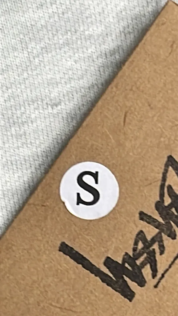 Black Hoodie With White Script Back Print — warehouse QC photo 1