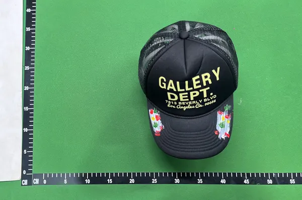 Black Mesh Trucker Cap With Painted Floral Detail — warehouse QC photo 1