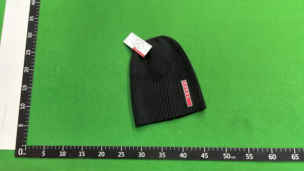 Black Ribbed Knit Beanie With Side Tab — warehouse QC photo 1