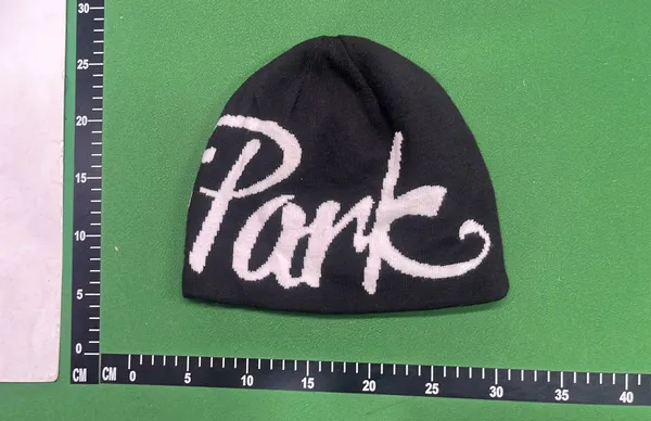 Black Knit Beanie With Script Lettering — warehouse QC photo 1