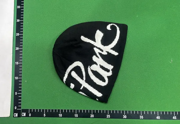 Black Knit Beanie With Script Lettering — warehouse QC photo 3