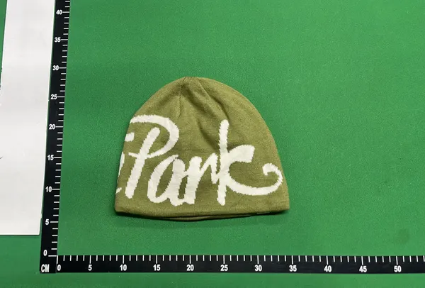 Black Knit Beanie With Script Lettering — warehouse QC photo 4