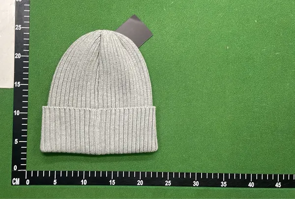 Black Ribbed Beanie With Square Woven Patch — warehouse QC photo 5